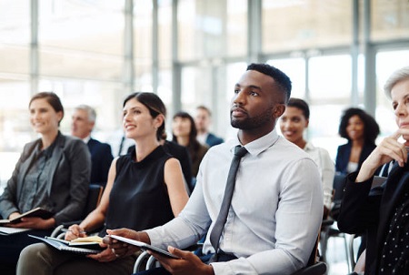 Shot Of A Group Of Businesspeople Attending A Conference